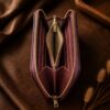 Tannor Irodori hand-woven cowhide long wallet in Burgundy, open interior showing the zip coin pocket