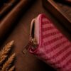 Tannor Irodori hand-woven cowhide long wallet in Fuchsia, close-up of the gold zip-around closure