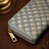 Tannor Irodori hand-woven cowhide long wallet in Cerulean, close-up of the gold zip-around closure