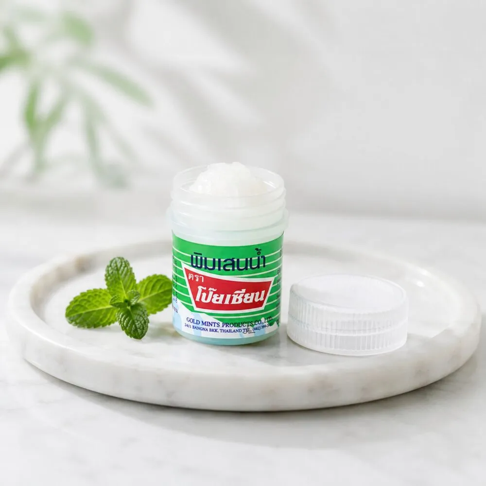 Poy Sian Pim Saen balm oil jar with fresh mint on a marble tray