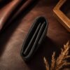 Tannor lizard-embossed leather envelope wallet in black, open, showing the note compartment and coin pocket