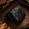 Tannor woven leather envelope wallet in black, side profile showing the slim depth