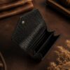 Tannor woven leather envelope wallet in black, open, showing the card slots