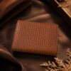 Tannor woven leather envelope wallet in chestnut brown, front view, studio