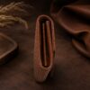 Tannor woven leather envelope wallet in chestnut brown, side profile showing the slim depth