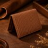 Tannor woven leather envelope wallet in chestnut brown, folded, showing the compact envelope shape