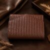 Tannor woven leather envelope wallet in dark chocolate, front view, studio