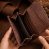 Tannor woven leather envelope wallet in dark chocolate, open, showing the card slots