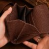Tannor woven leather envelope wallet in dark chocolate, open, showing the note compartment and coin pocket